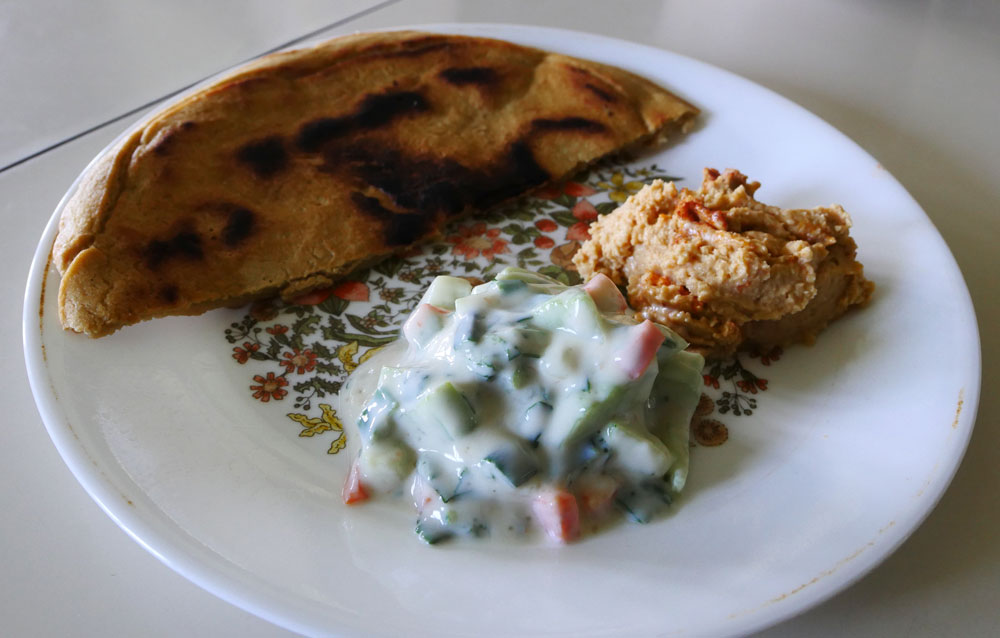 vegan yogurt cucumber salad with hummus and bread