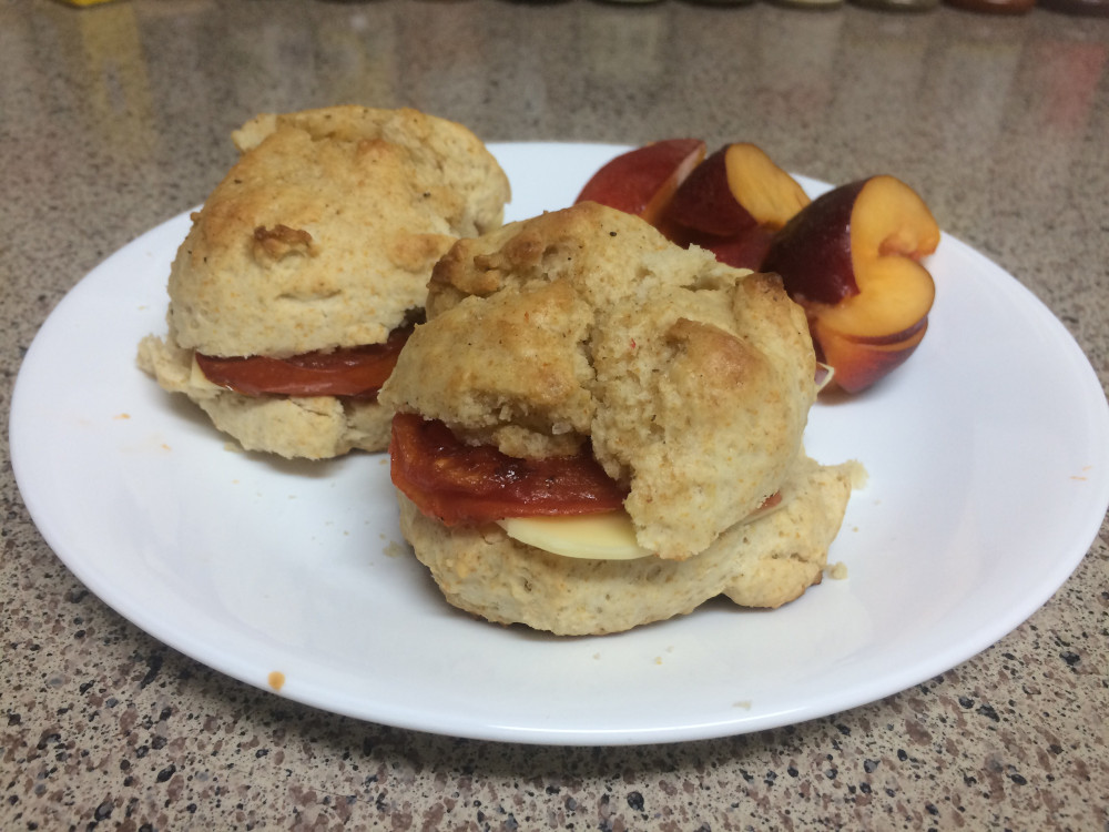 tomato and vegan smoked gouda biscuit sandwich with nectarine slices