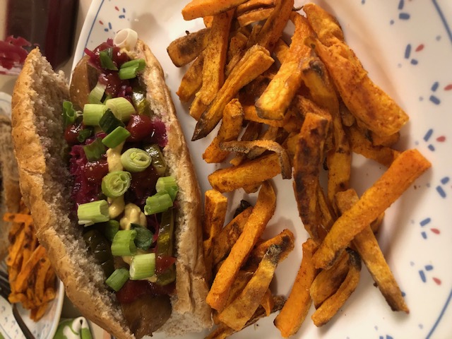 vegan "not hog" with ketchup and green onion with fries