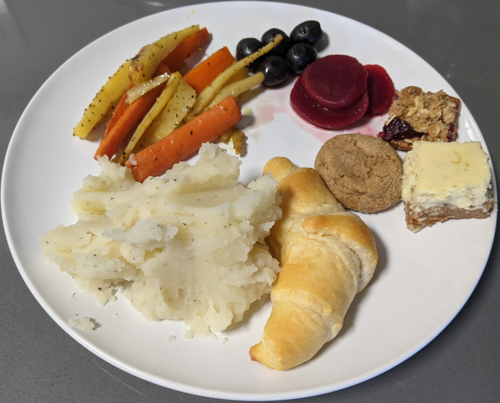 mashed potatoes, crescent roll, carrots and parsnips, cranberry sauce, and cookies