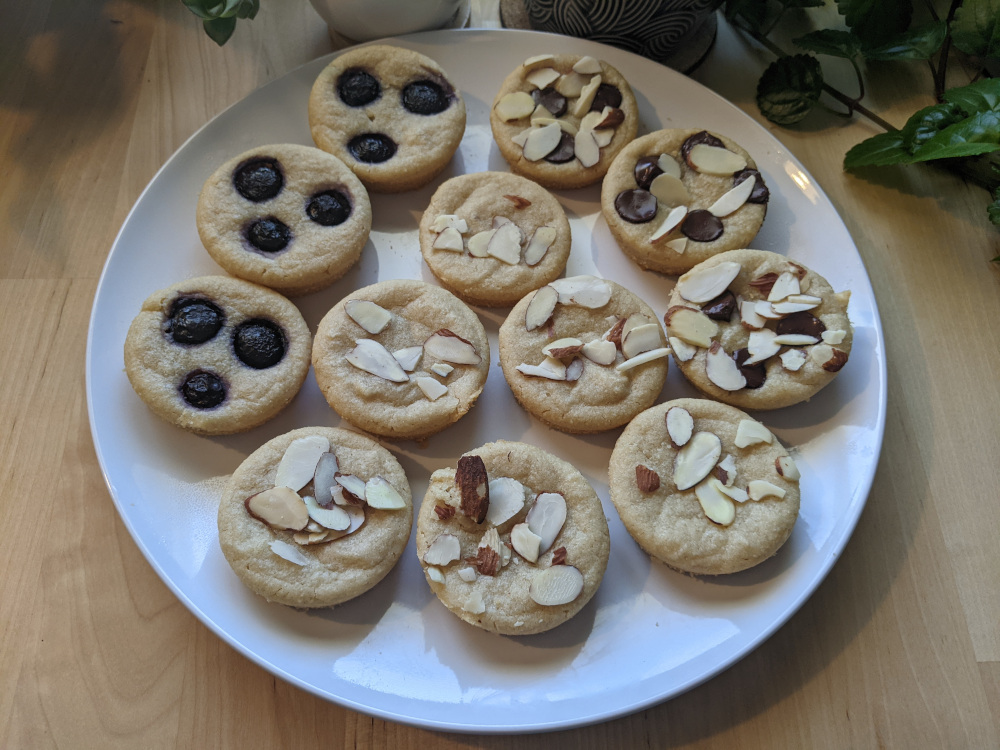 round vegan financiers with blueberries and almond slices