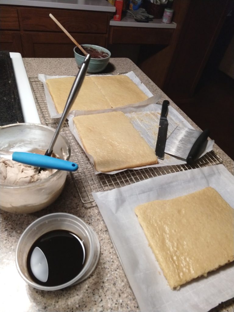 vegan white sponge cake with bowls of ganache, coffee syrup, and coffee buttercream