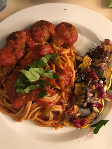 Plate of spaghetti with tomato sauce and bean balls, squash dish on the side