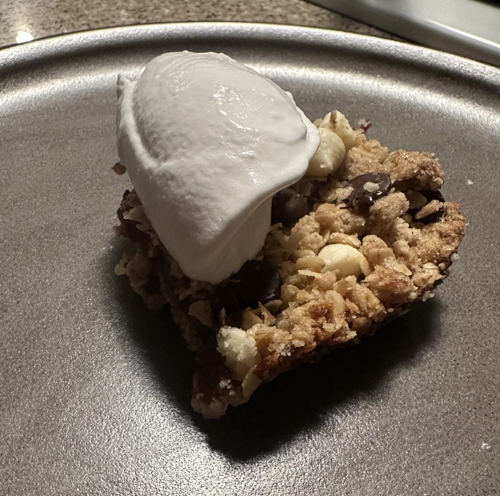 Cut bar on plate with whipped cream