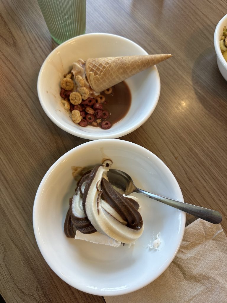 two bowls of ice cream, one with a cone